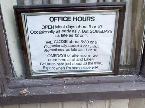 window sign with complicated listing of office hours